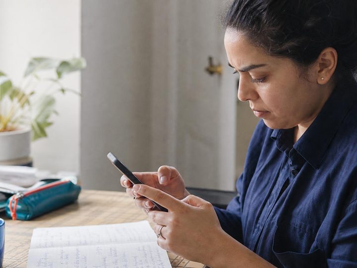 A person types a query on their phone